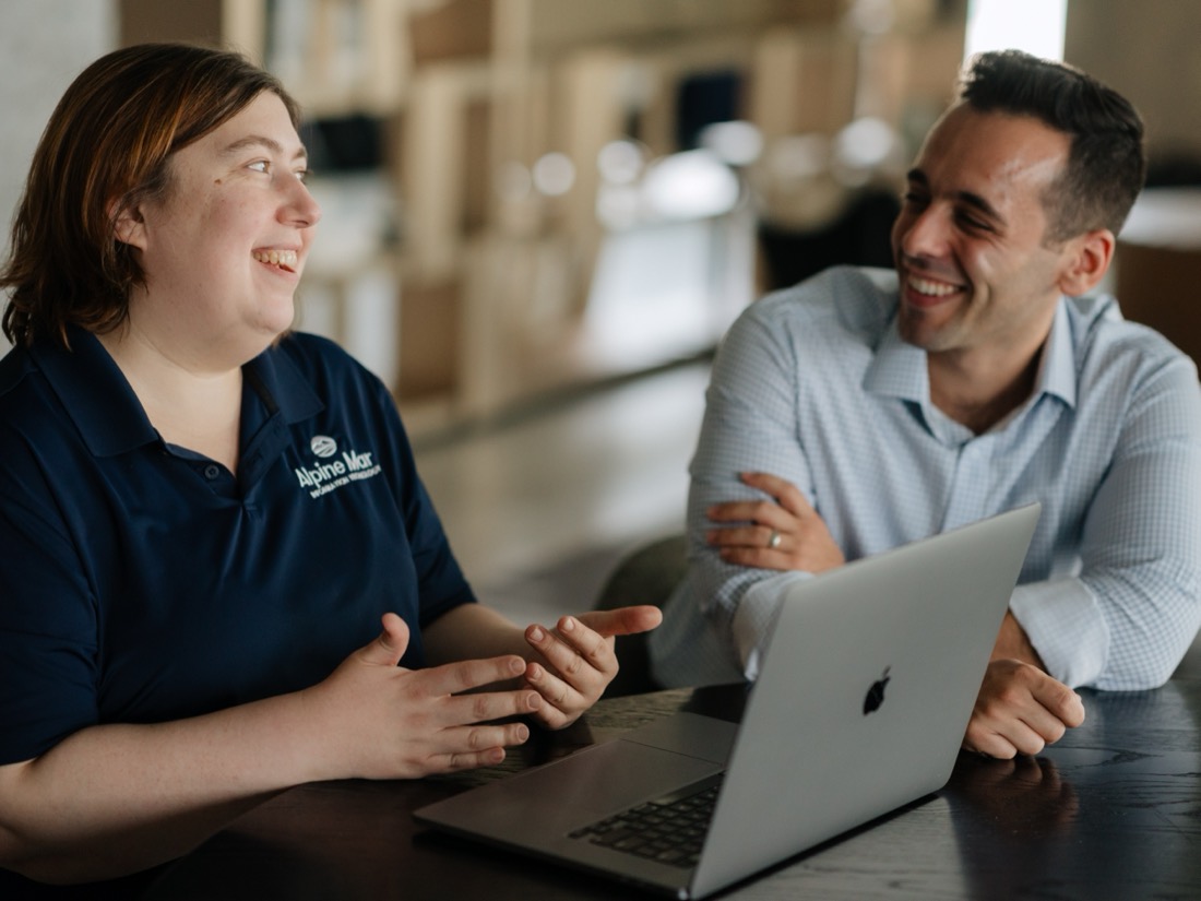 Two Alpine Mar team members sharing a laugh during a working session
